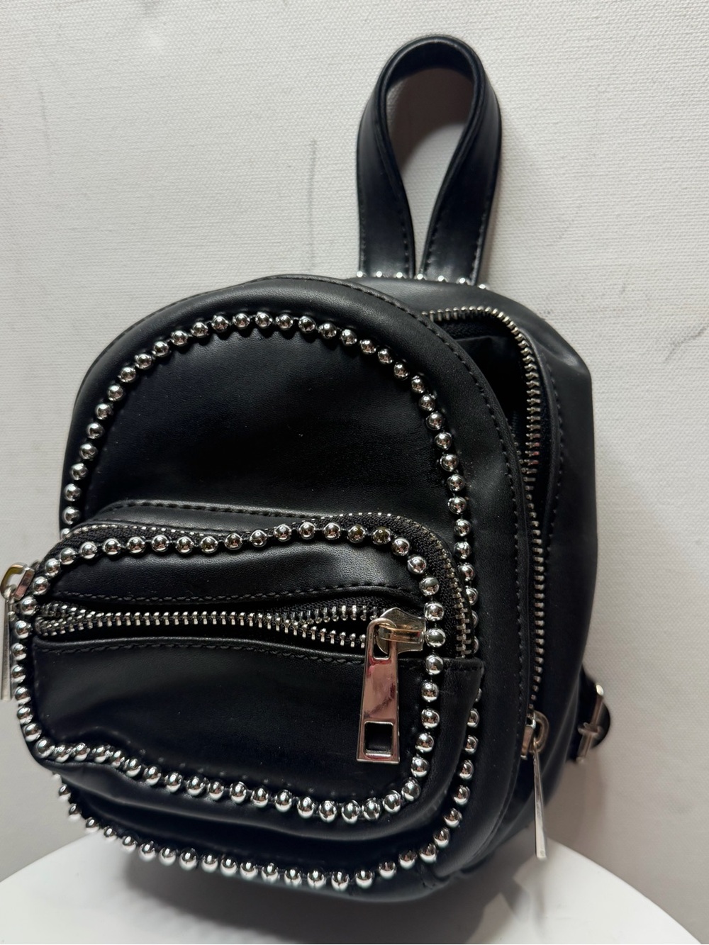 black faux leather mini-backpack,